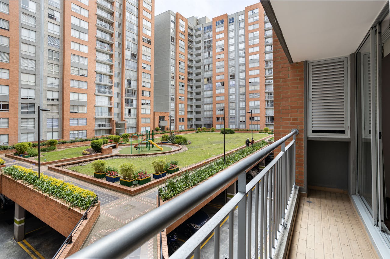 large, enclosed apartment complex with a playground in the center
