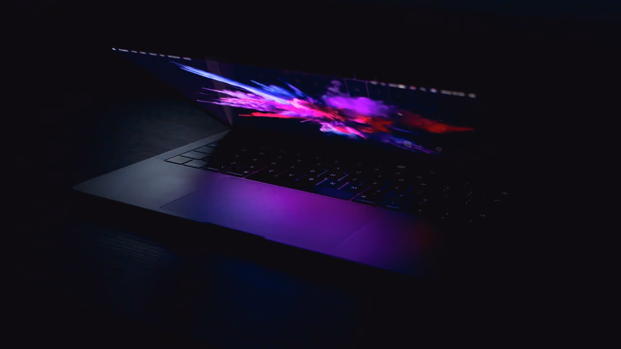 A closing laptop in a dark room