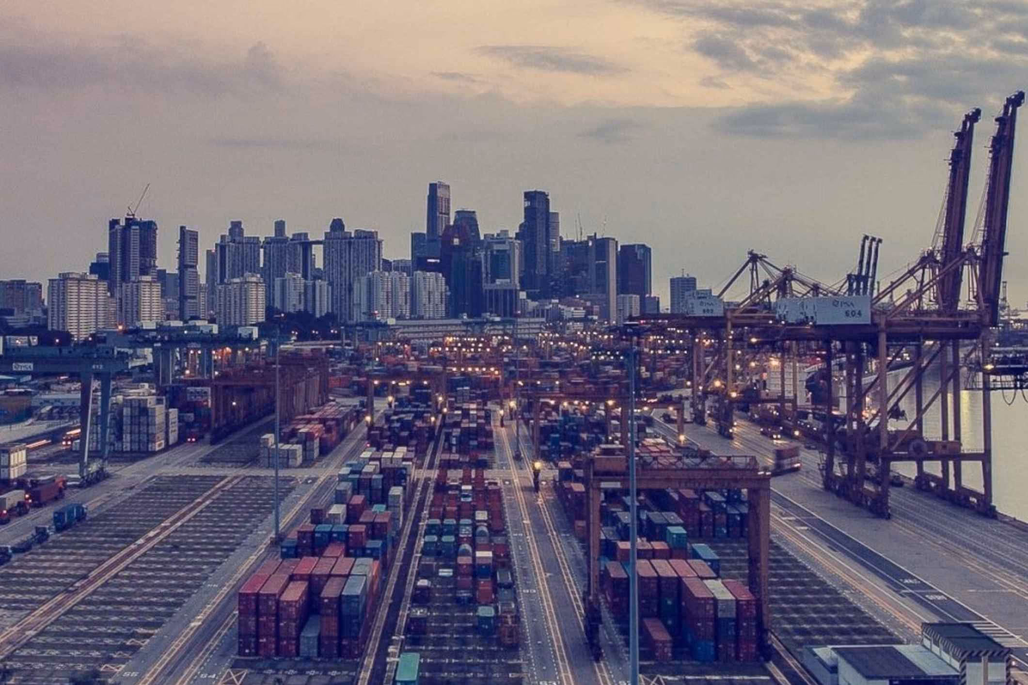 Shipping port with cargo cranes at dusk, representing a Galveston docks asbestos lawsuit.