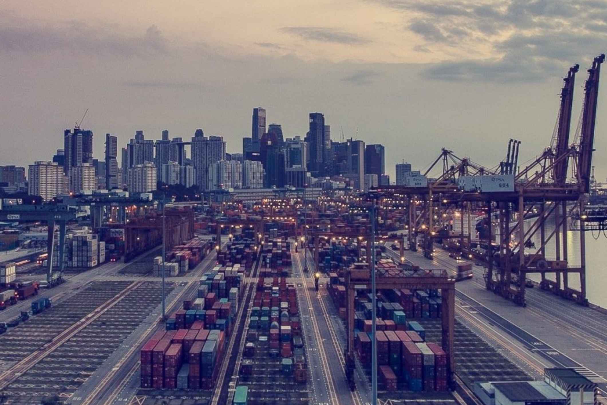 Shipping port with cargo cranes at dusk, representing a Galveston docks asbestos lawsuit.