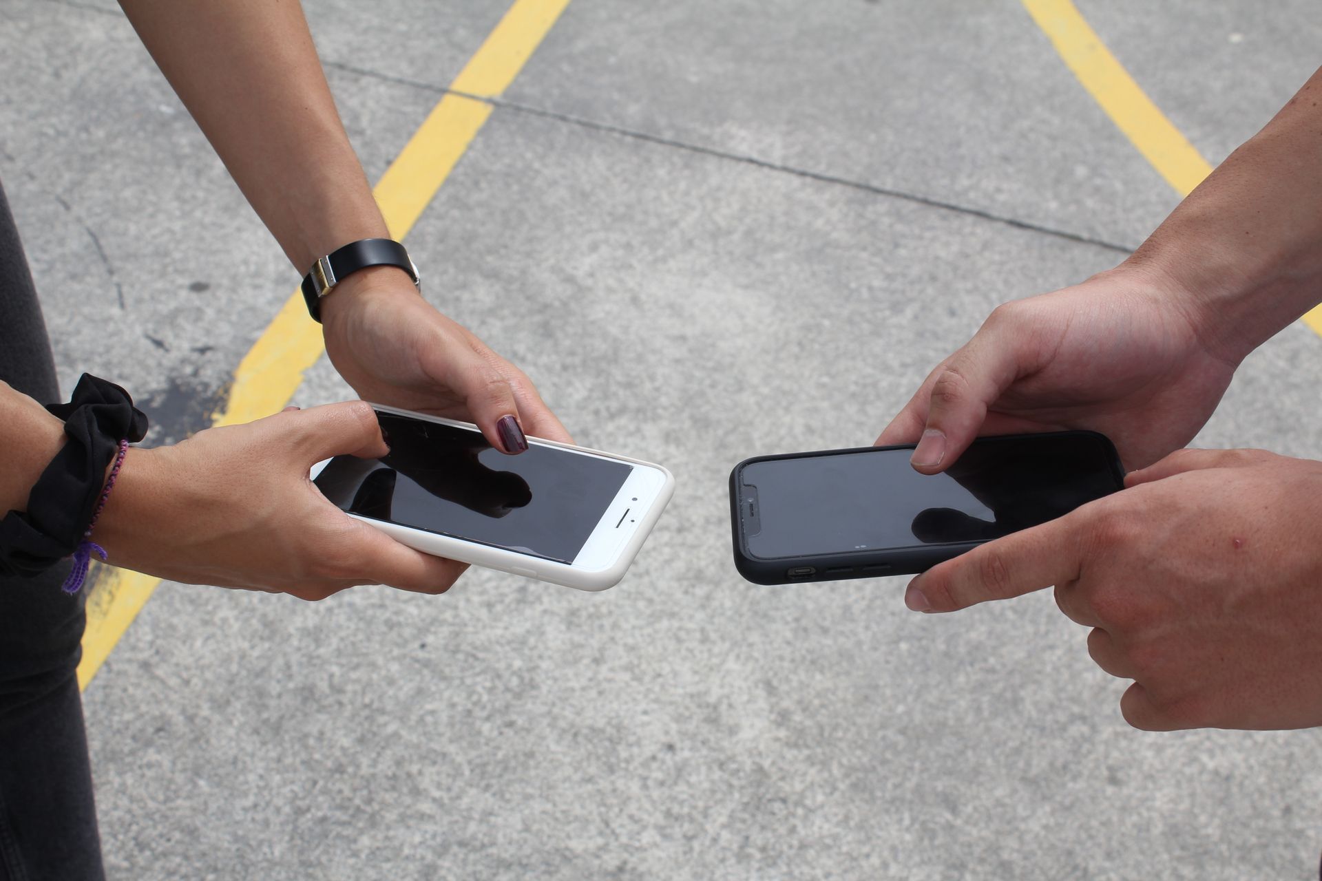 two people holding their phones together