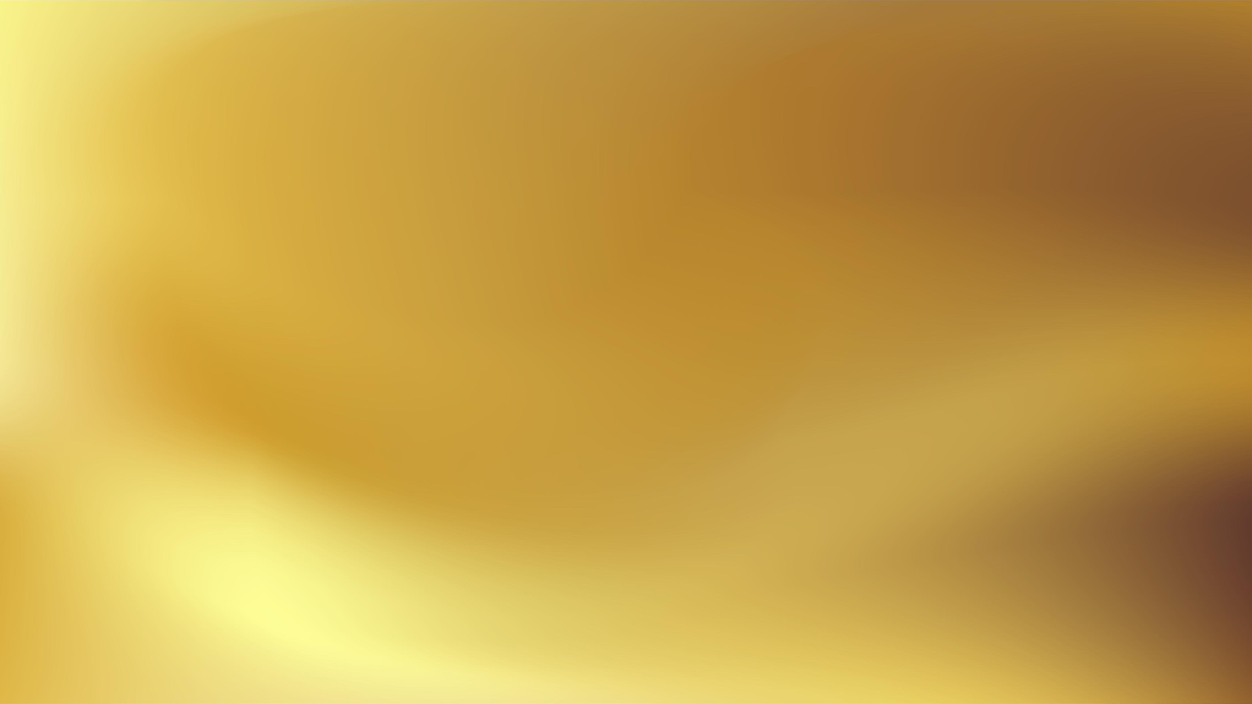 Blurred gradient background with flowing golden hues and light reflections.
