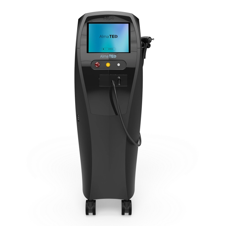Black Alma TED medical device with screen, buttons, and attached handheld applicator on wheels.