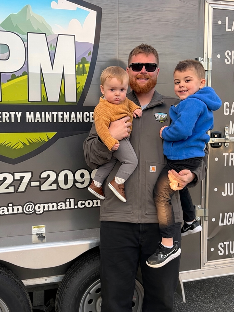 Gray's Property Maintenance owners in front of company truck