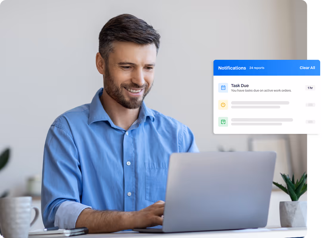 A maintenance professional reviewing task-due notifications and real-time work order status updates on a laptop.