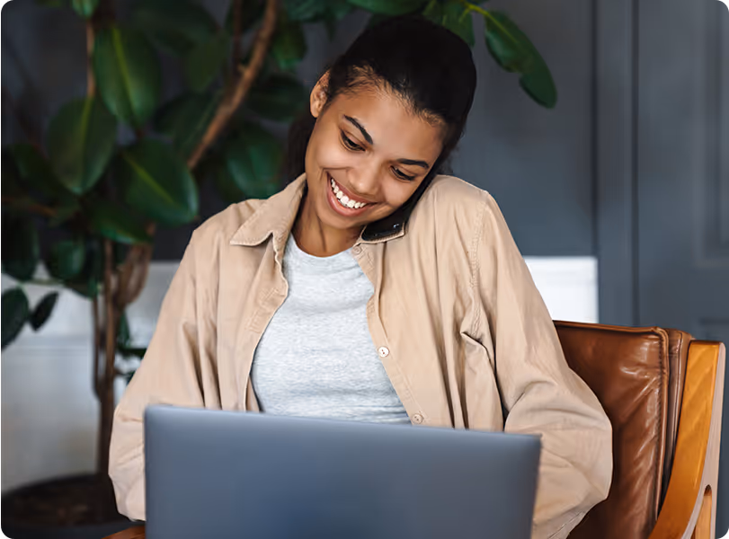 A facility manager on a phone call while using a laptop to manage maintenance operations and service requests.