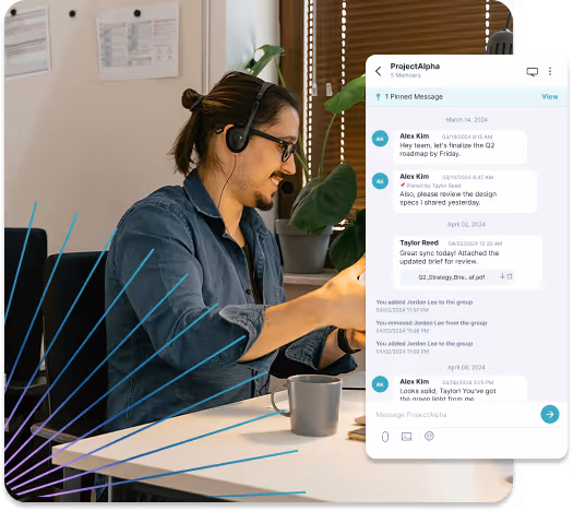 Man wearing headset and glasses working at desk with laptop and coffee, next to a chat window showing team messages about project updates.