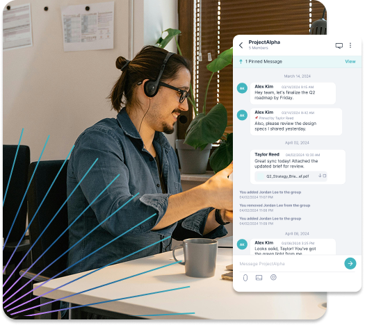 Man wearing headset and glasses working at desk with laptop and coffee, next to a chat window showing team messages about project updates.