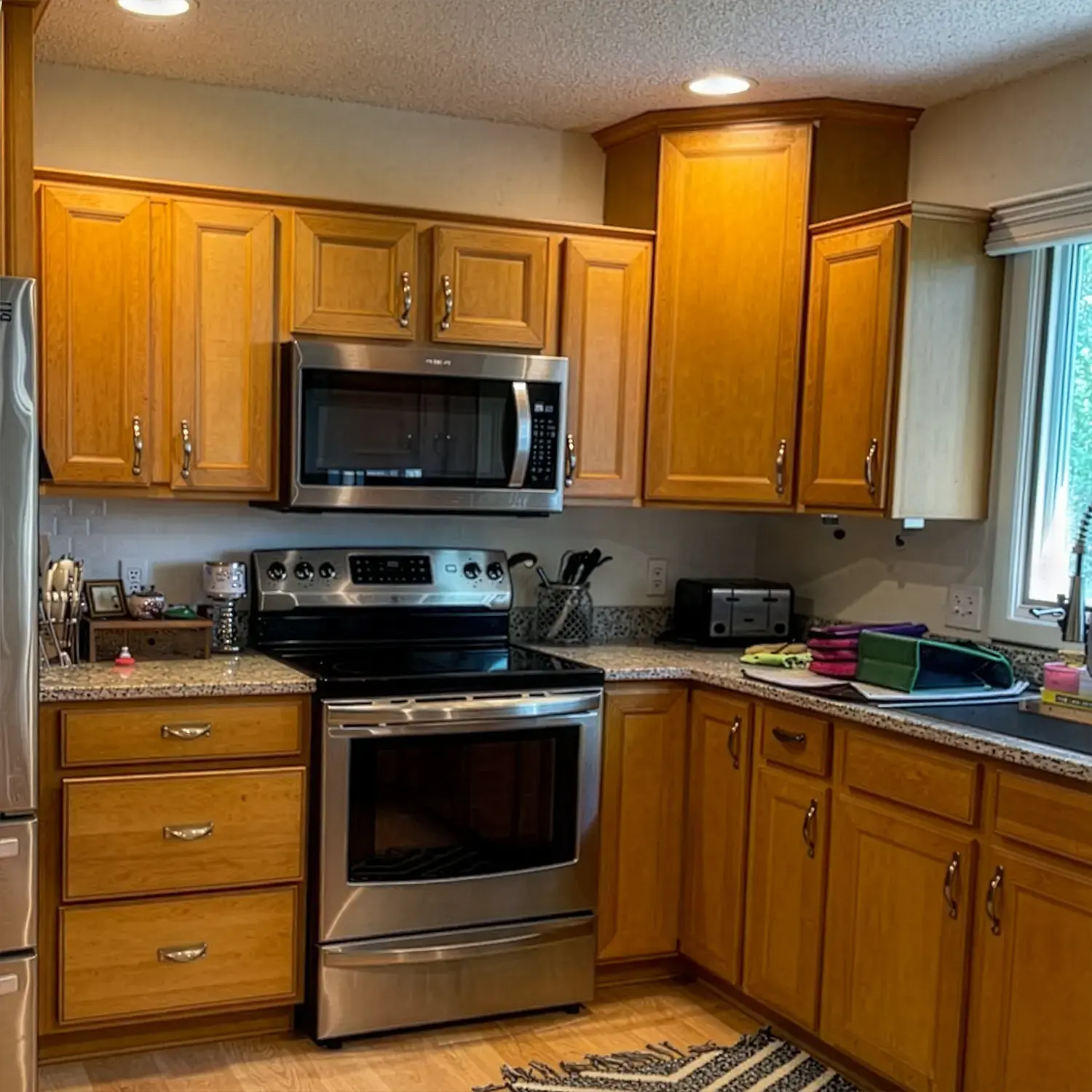 Kitchen with original oak cabinets before cabinet refinishing in Billings Montana