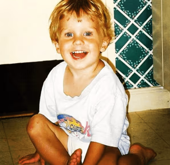 Flags crossed under a beam of light in a dimly lit stone archway.
