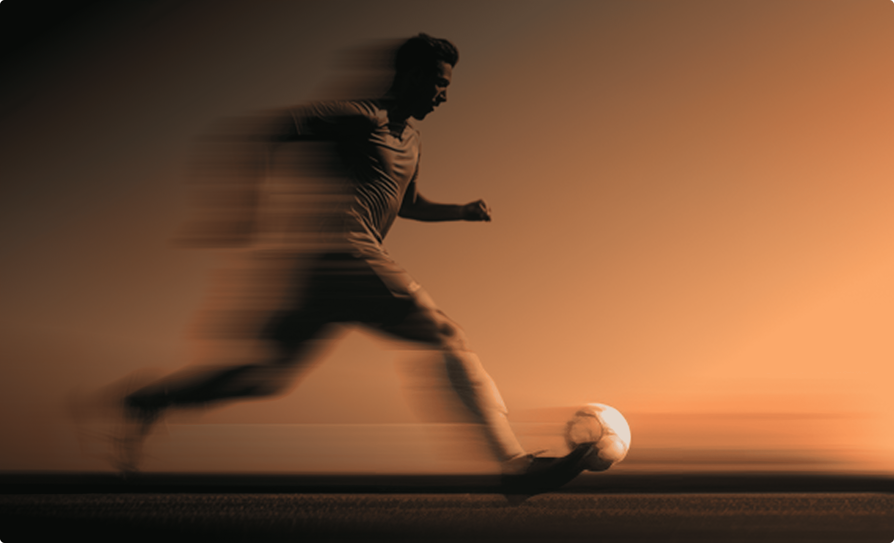 Silhouetted soccer player kicking a ball with motion blur on an orange background.