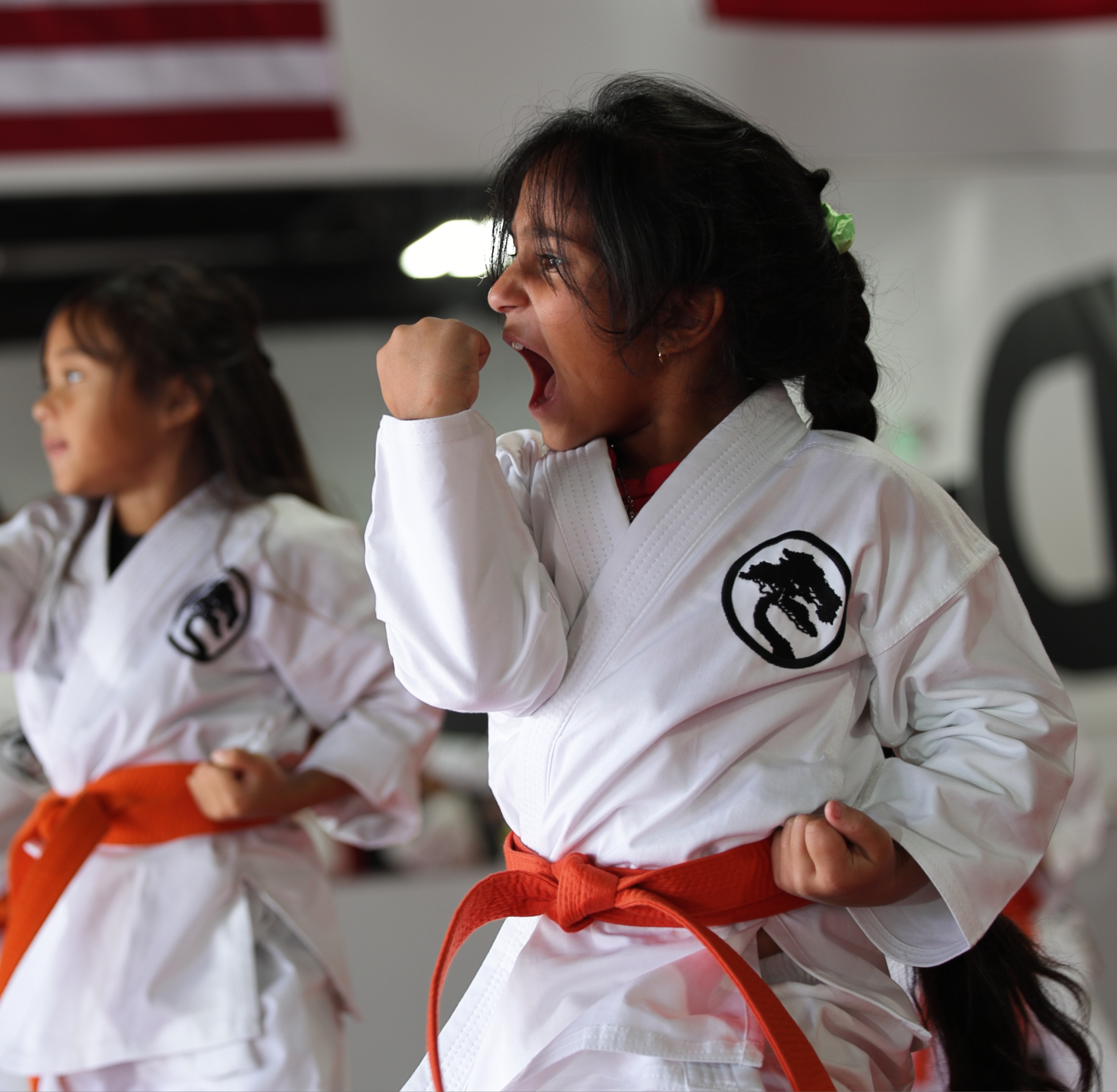 Photo of children in a karate class practicing synchronized movements.