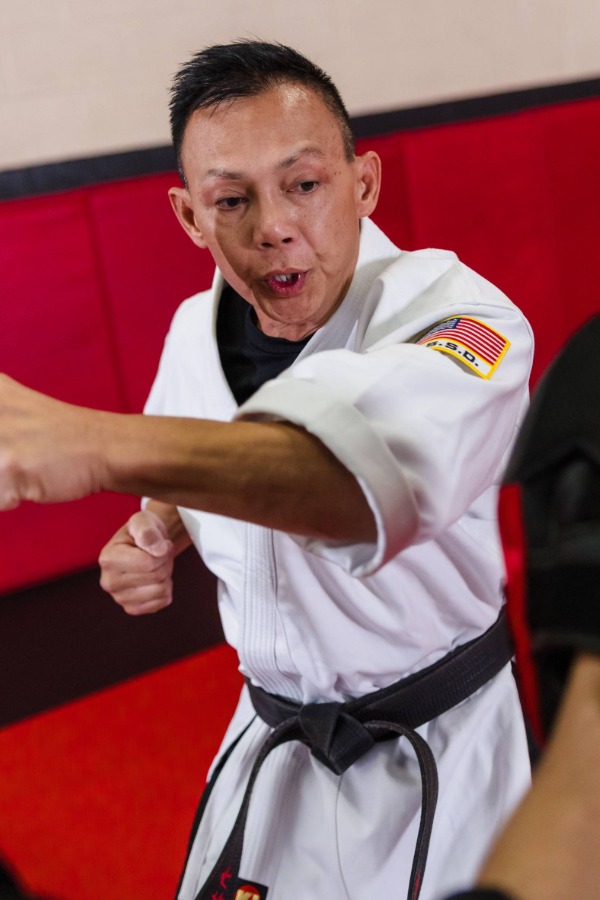 A young purple belt karate student practices the eight-point blocking system.