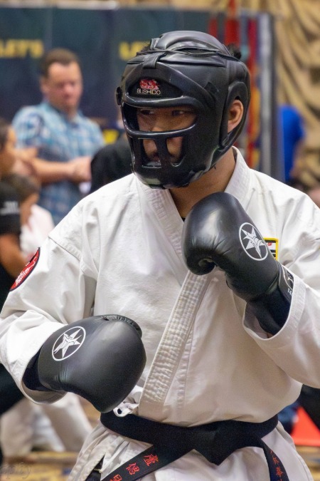 A young purple belt karate student practices the eight-point blocking system.
