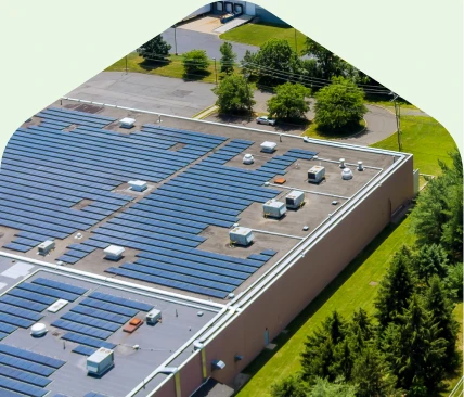 Onsite Solar for Commercial Facilities Aerial view of rooftop solar panels installed on a large commercial building.
