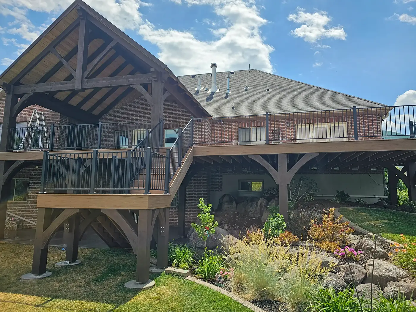 Close view of a timber gable over an elevated deck with black railing