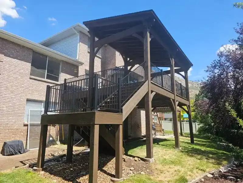 Elevated deck with a brown timber hip-roof pavilion and black railing