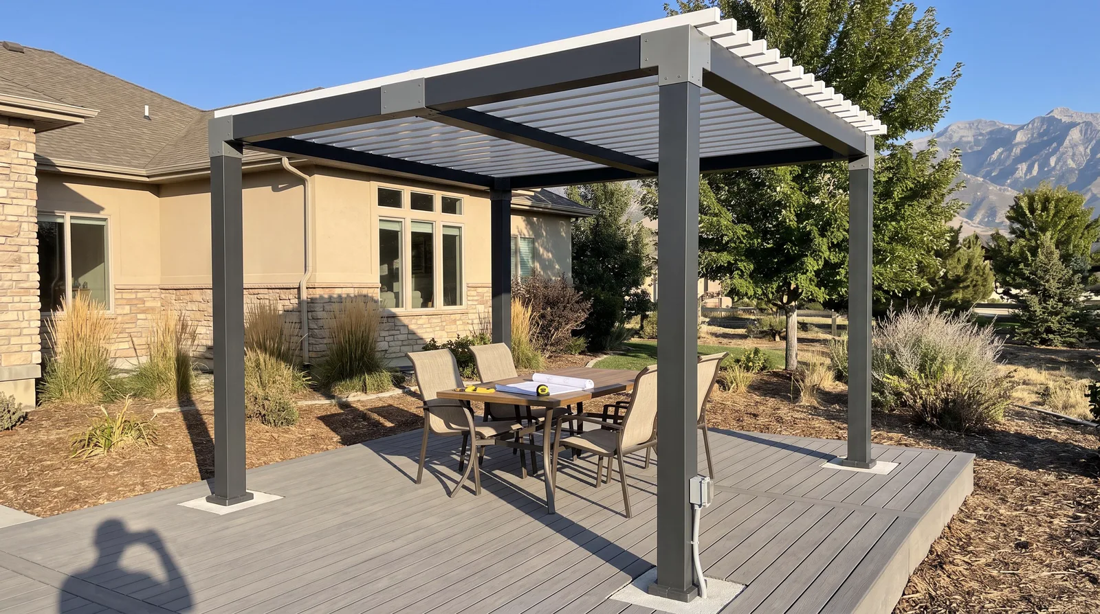 Freestanding louvered pergola over a patio dining set on composite decking