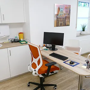 Sprechzimmer der Praxis am Bertrandishof mit Schreibtisch und Computer