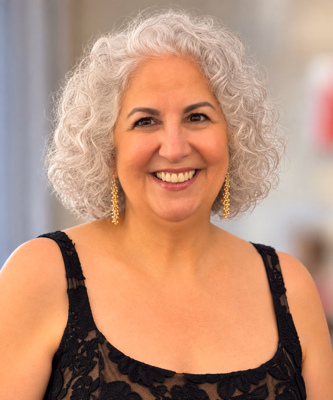 A headshot Image of Olga Barone-Allan smiling.