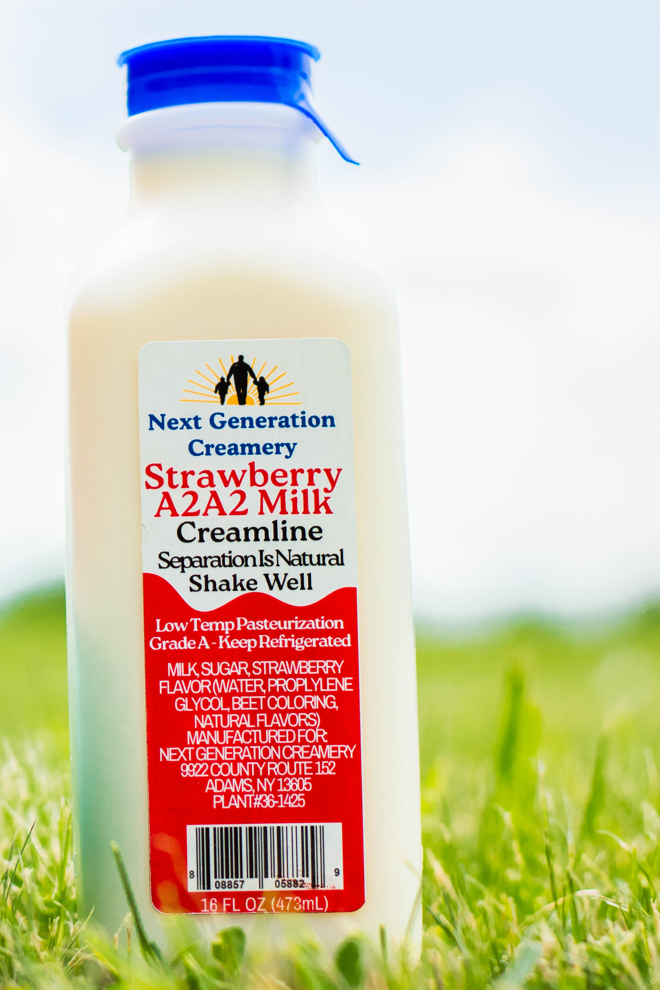 A glass bottle of Next Generation Creamery seasonal strawberry milk