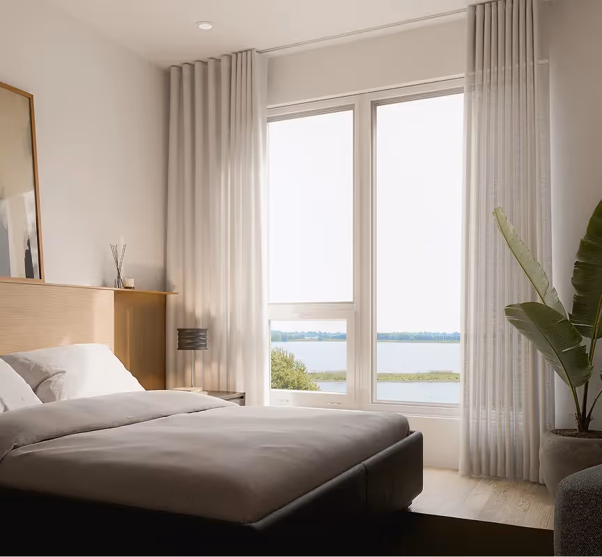 Minimalist bedroom with wooden headboard and river view