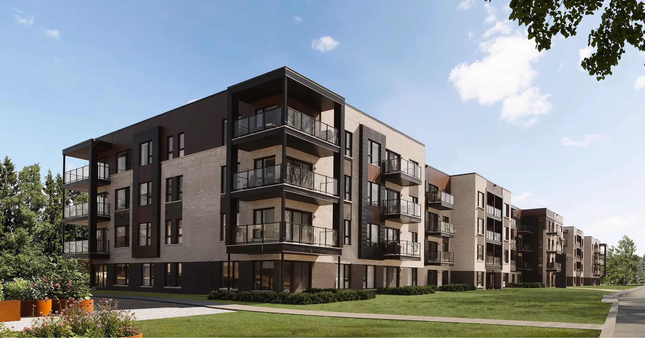 Facade of a modern brick residential building with balconies and landscaping