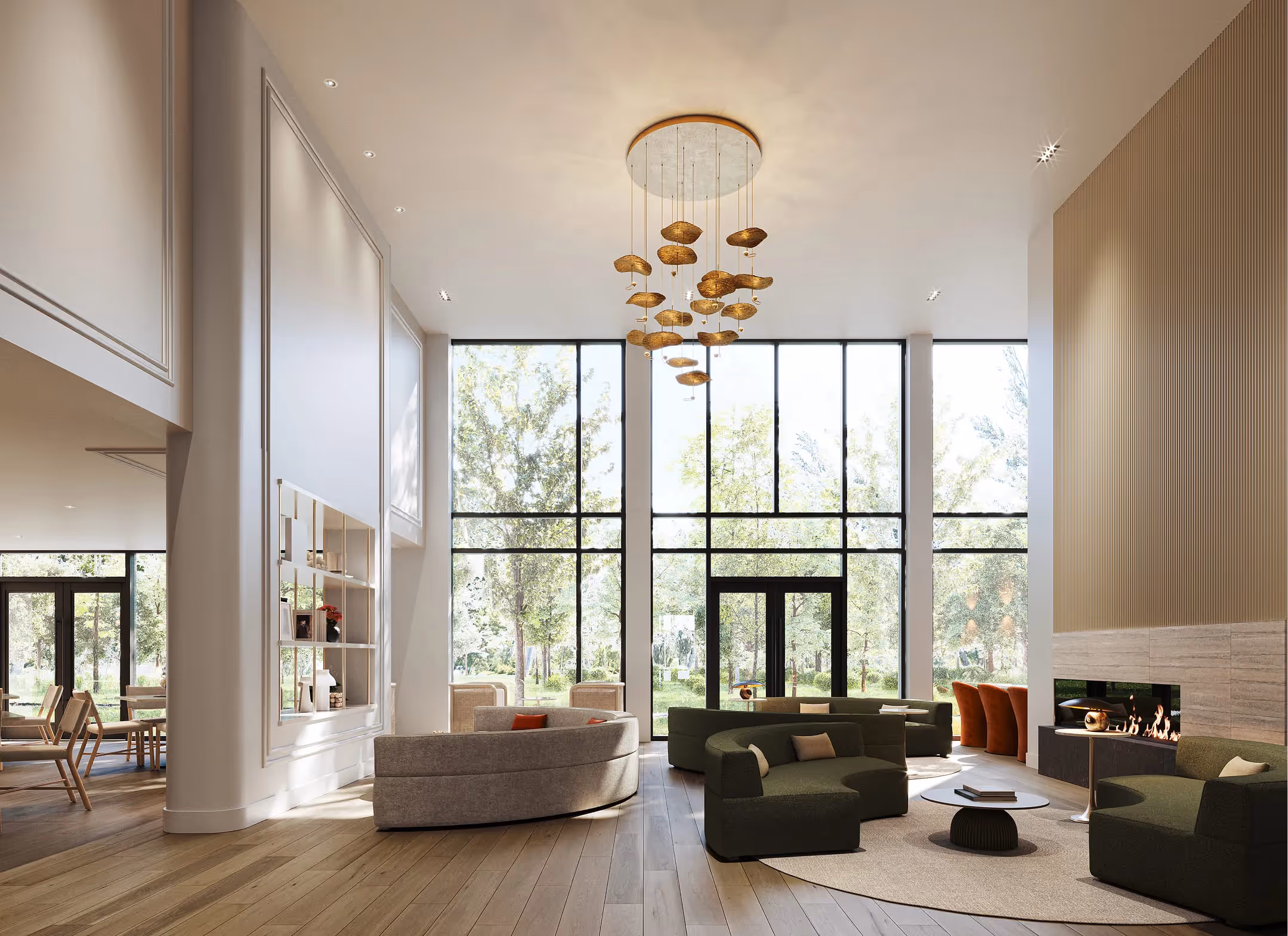 Bright common hall with rounded sofas, fireplace, fireplace, gold chandelier, and large picture windows overlooking the greenery