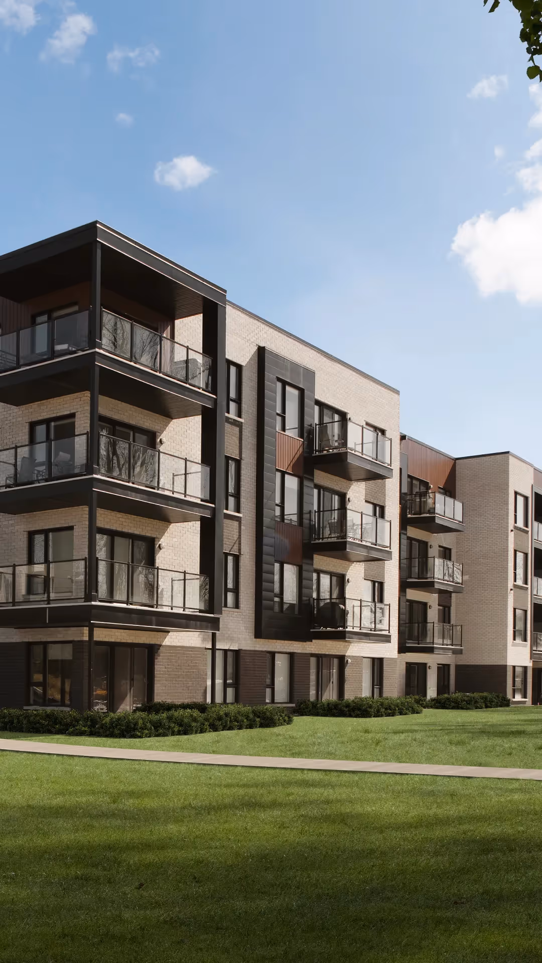Facade of a modern residential building with balconies and lawn