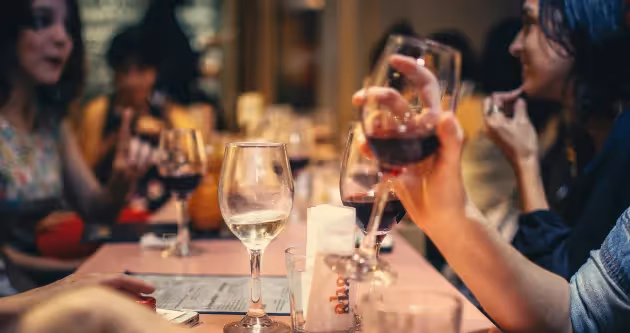 Group of people toasting at a restaurant table