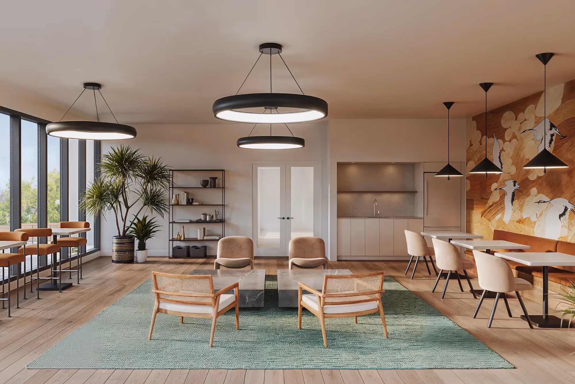 Modern and bright common area with lounge and dining tables at AlterEGO sur le Fleuve rental complex in Brossard.