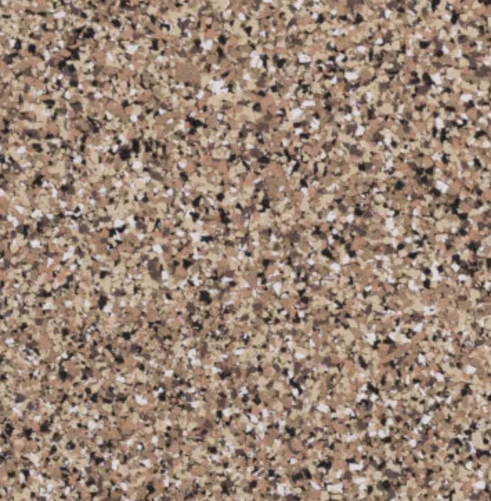 Outdoor patio with modern seating around a fire pit, gas grill, cracked concrete floor, and surrounding garden with trees and mountains in the background.