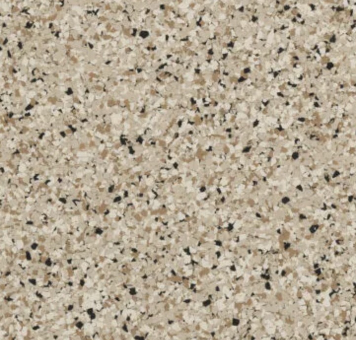 Bright modern living room with large windows overlooking snowy mountains, featuring a gray sectional sofa, two wooden lounge chairs, and a potted plant.