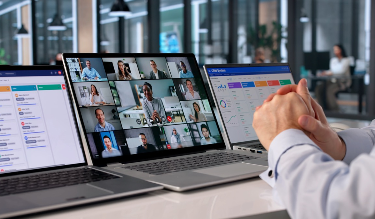 Sales professional in a video conference with CRM dashboards