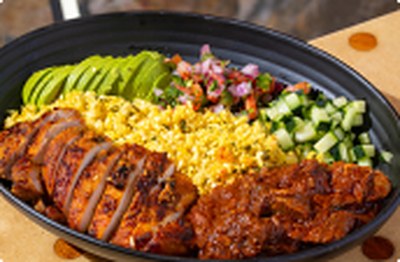 Curry Up Now Protein Bowl: tandoori chicken and lamb rogan josh with cauliflower rice, cotija, avocado, pico and cucumber