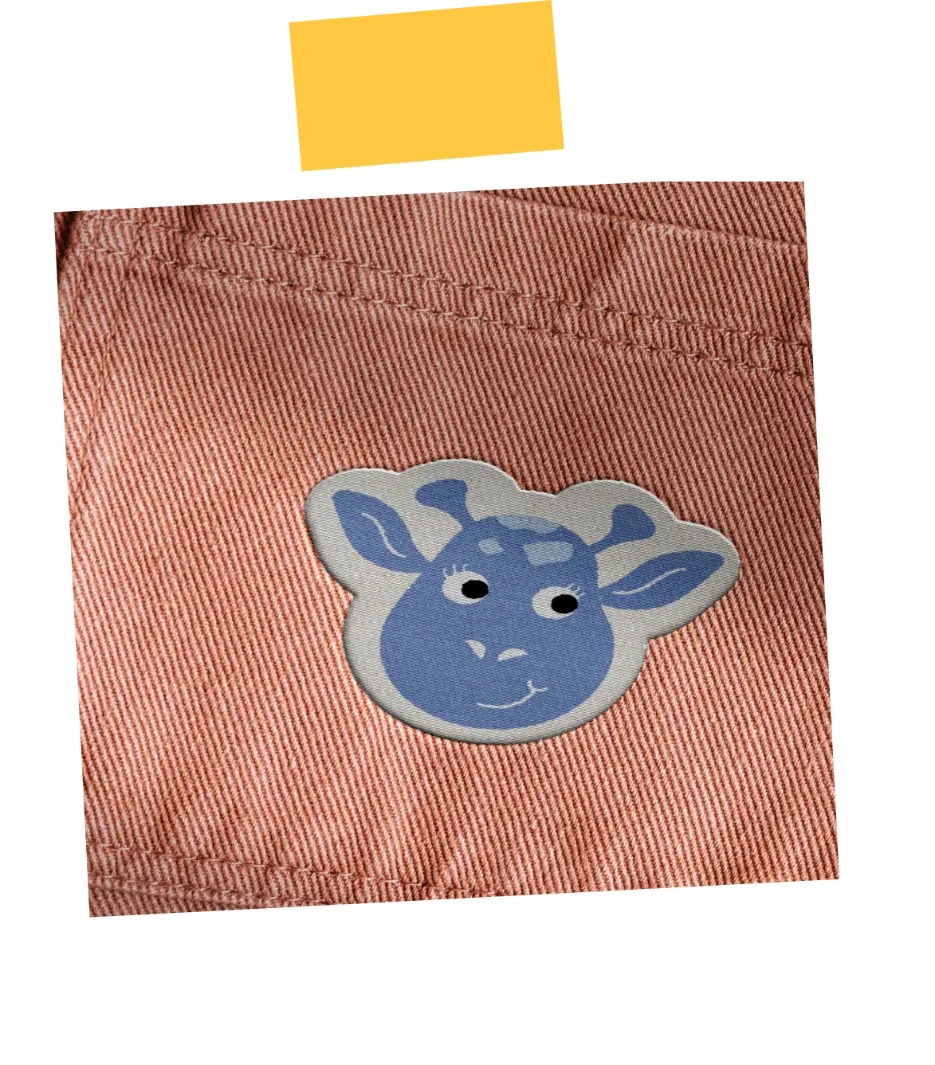 Blue cartoon giraffe face patch on pinkish-red fabric with visible stitching.