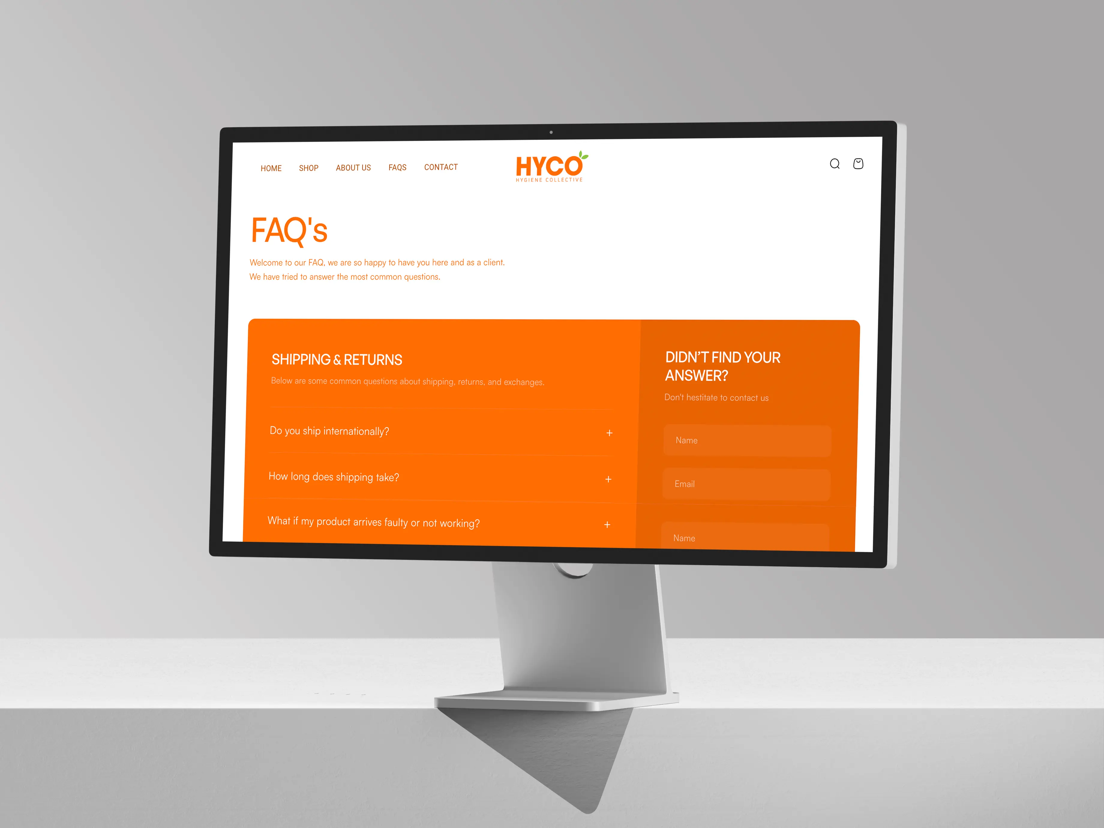 Computer monitor displaying Hyco website FAQ page with sections on shipping and returns and a contact form on the right.