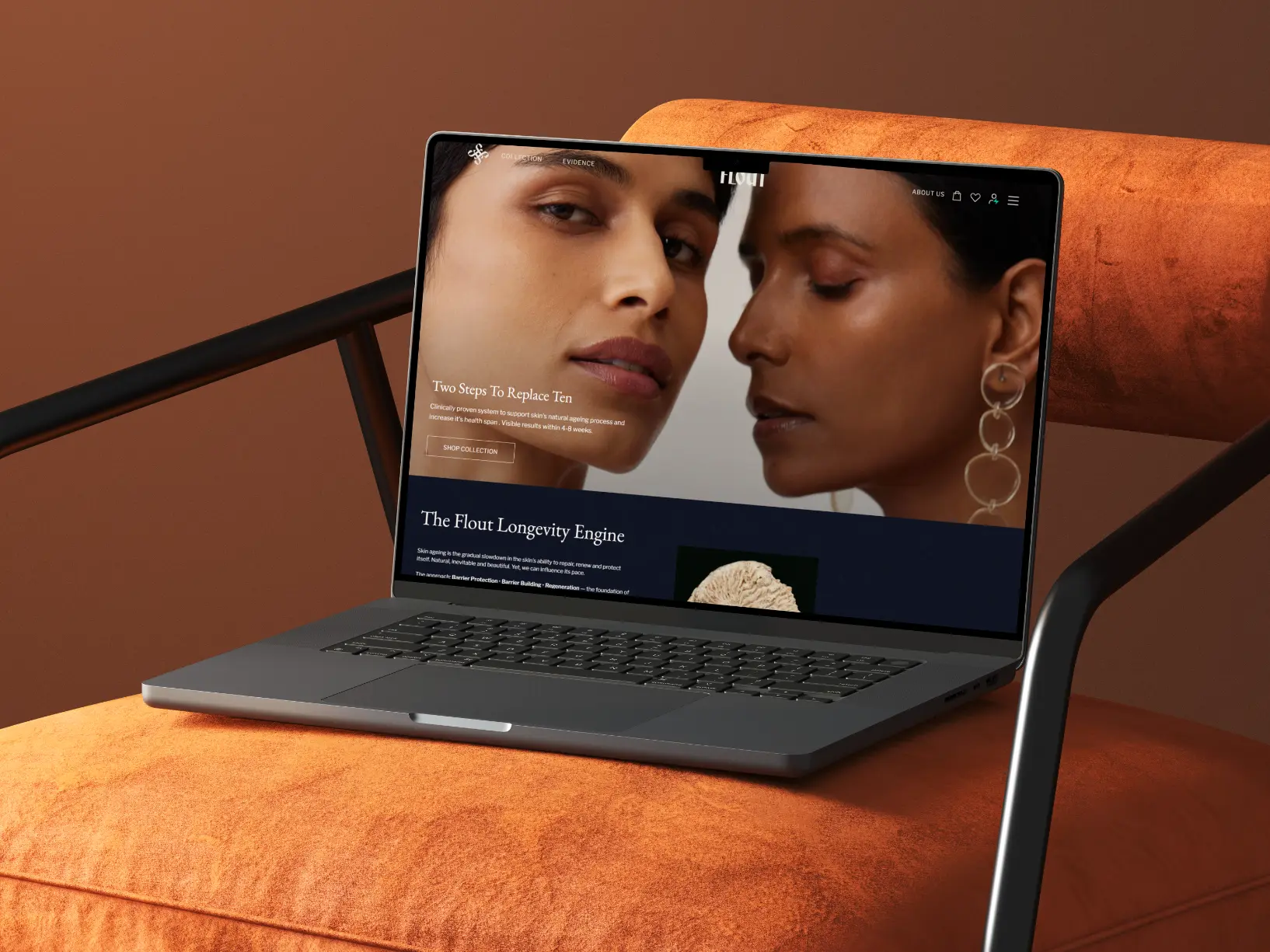 Open laptop displaying skincare website with close-up of two women's faces on an orange chair.