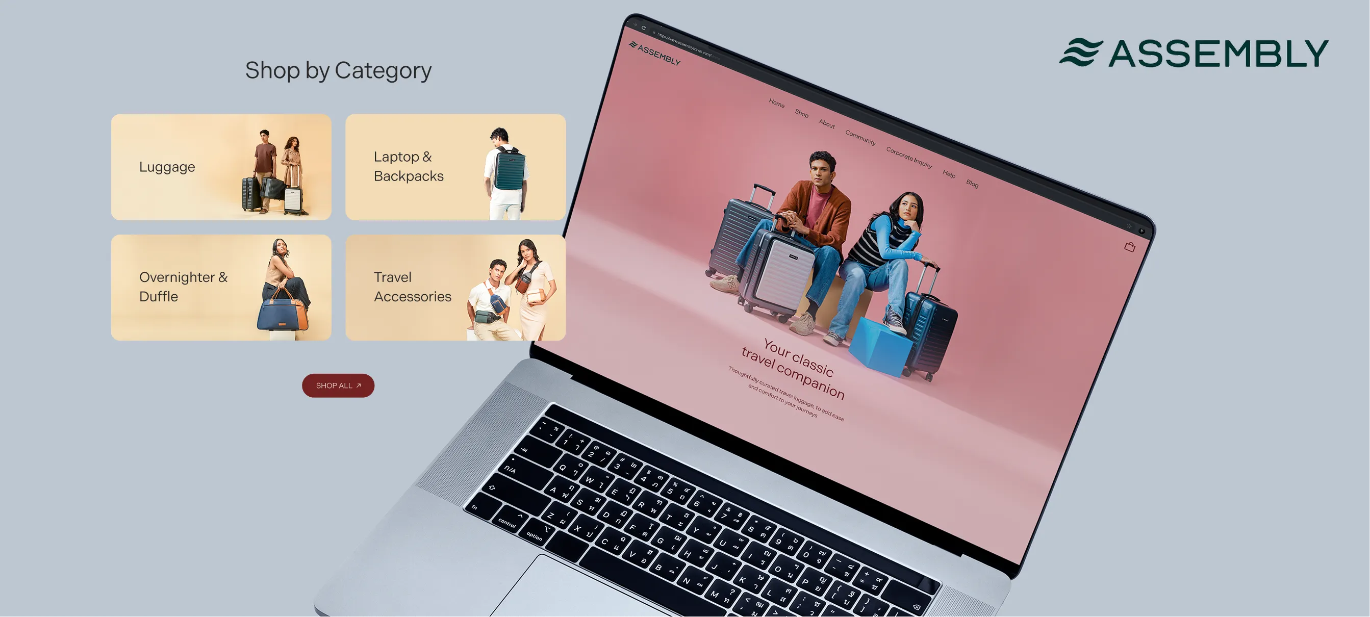 Open laptop showing Assembly website with a pink background featuring a man and woman sitting with suitcases and a tagline 'Your classic travel companion.' Next to the laptop are product category boxes for Luggage, Laptop & Backpacks, Overnighter & Duffle, and Travel Accessories, each with a model posing with the items. Assembly logo is in the top right corner.