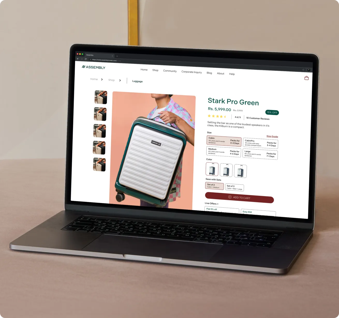 Open laptop displaying an online shopping page for a green and white hard-shell suitcase named Stark Pro Green, priced at Rs. 5,999 with a 15% discount and customer ratings, showing size options, color variants, and add to cart button.