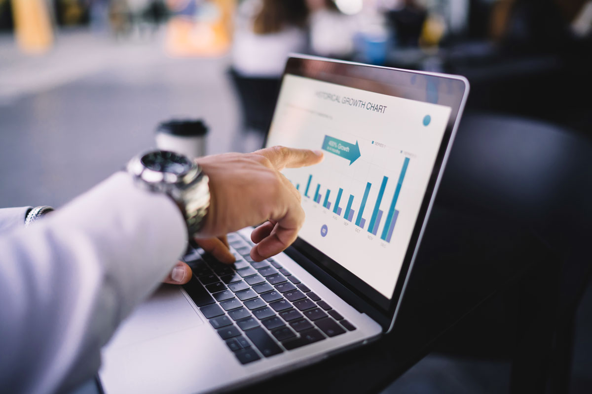 image of hands typing on a laptop with scientific data