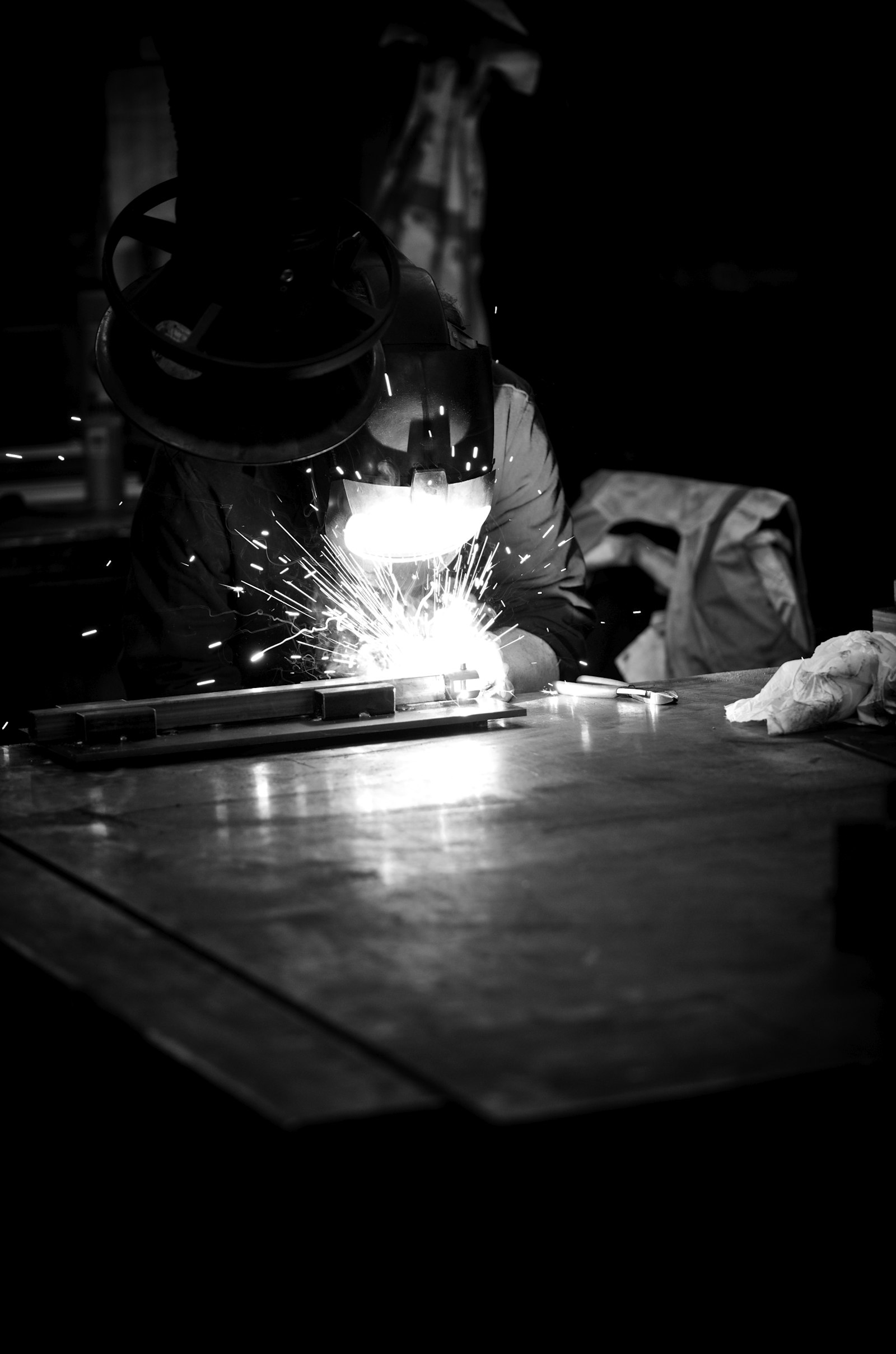 Skilled welding technician working with sparks flying