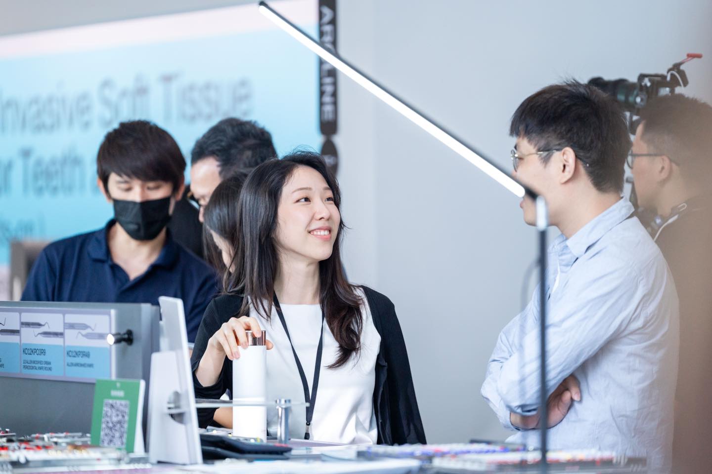 Participants discuss dental products at an exhibition