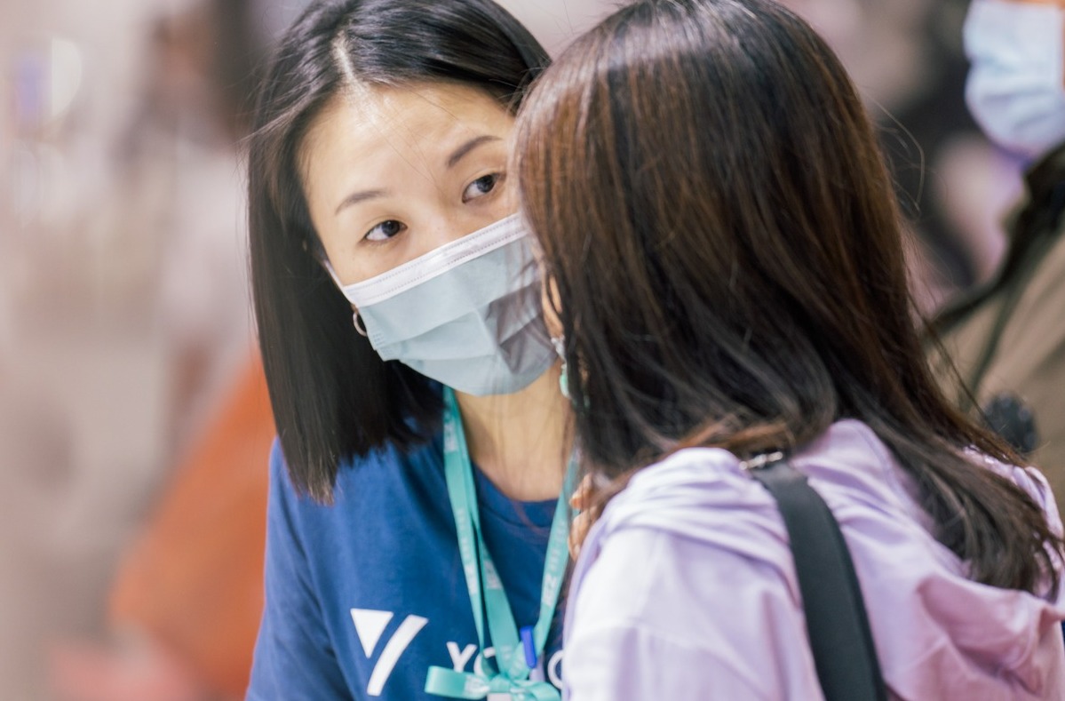 A Yong Chieh team member talks with an event participant