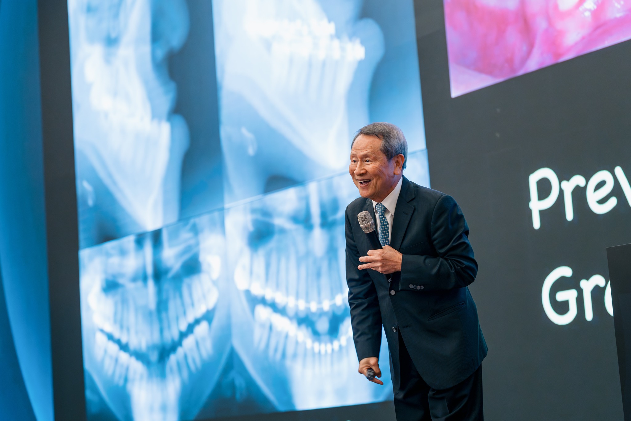 A speaker presents at a dental education lecture