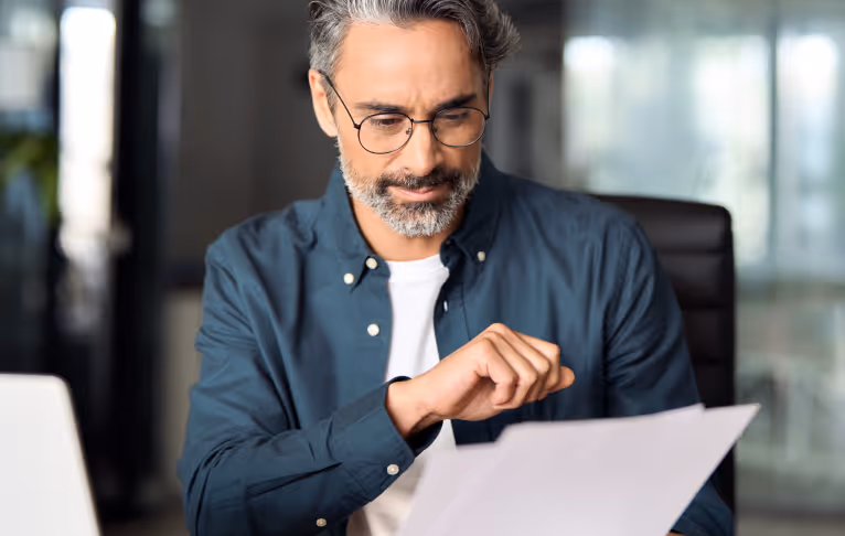 Business professional in a suit reviewing documents