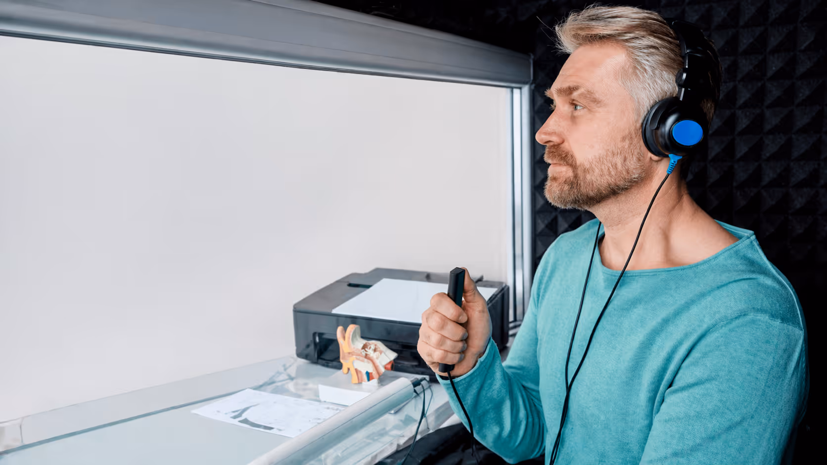 Person undergoing a hearing test wearing audiometric headphones.