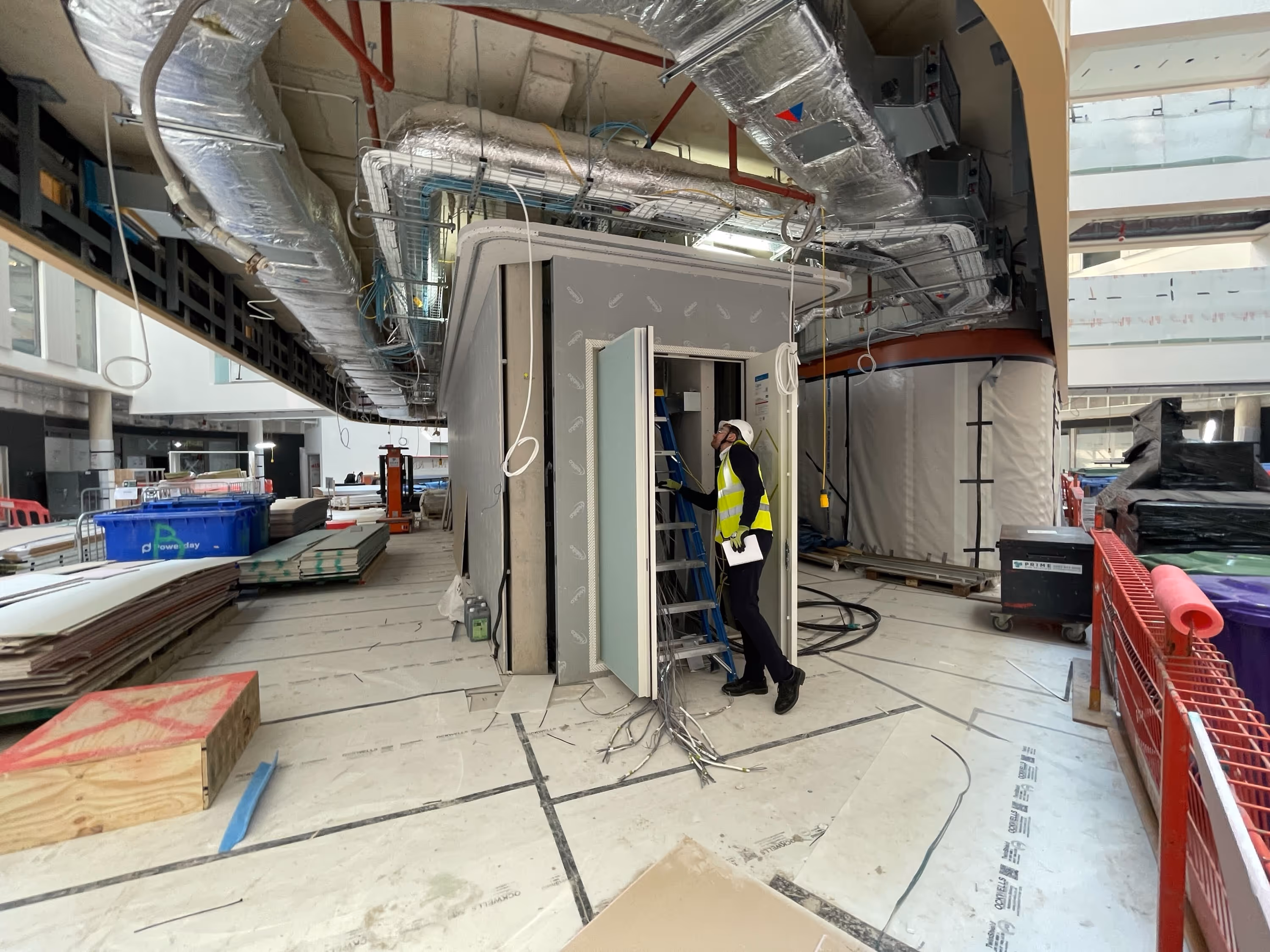 Worker in a high-visibility vest in an industrial facility.