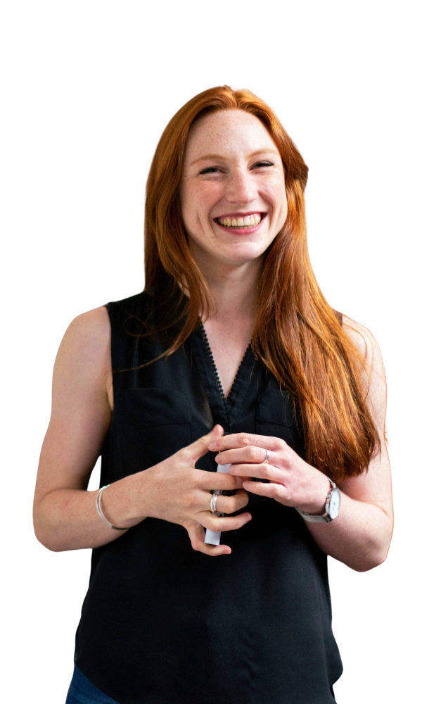 Portrait of a woman with long red hair smiling at the camera.