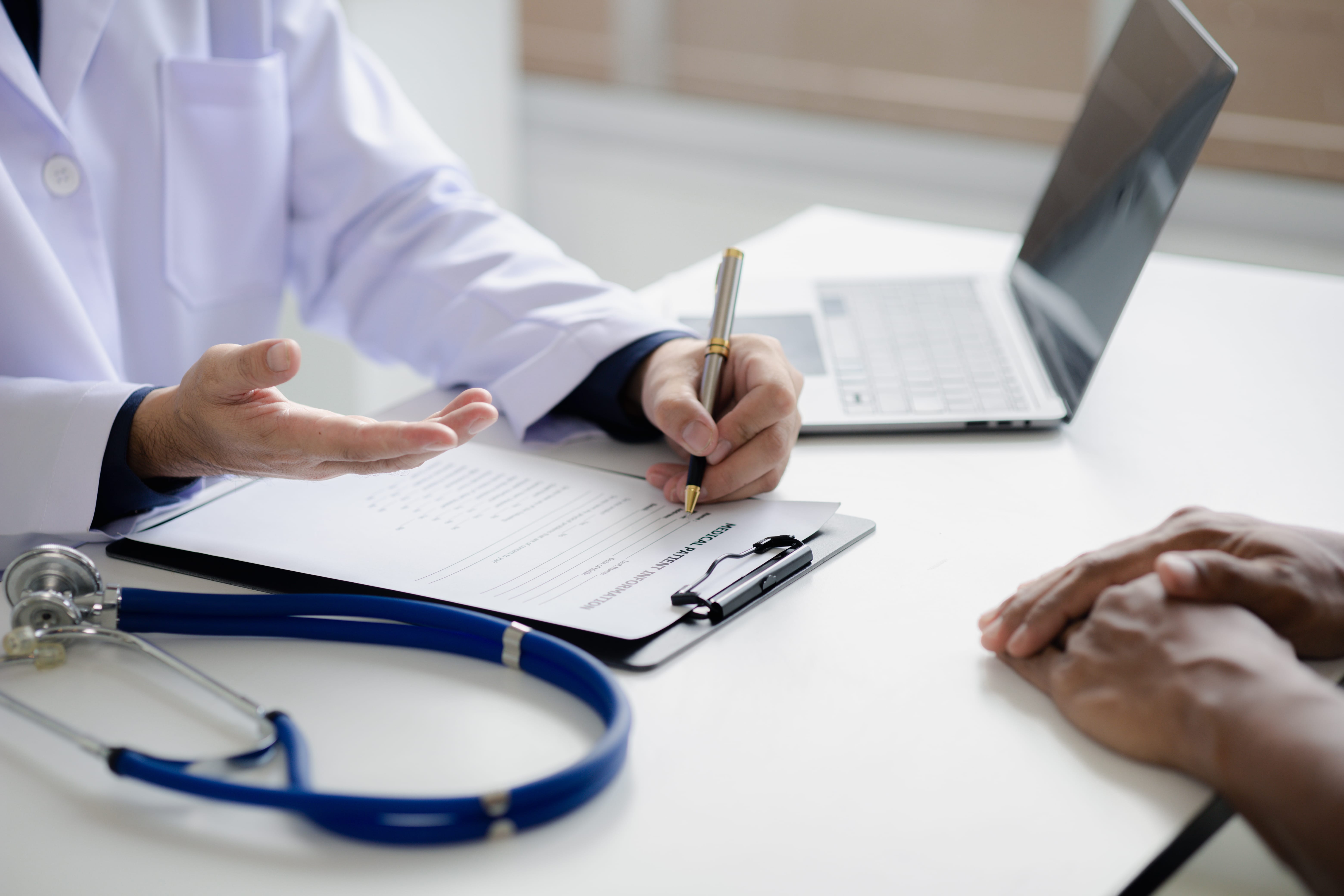 Doctor at a desk reviewing an injured employee's medical report